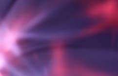 Abstract purple and pink light blurs on a dark background.