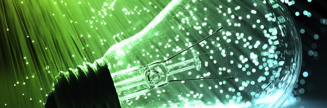 Lightbulb in front of a neon green and blue dynamic background