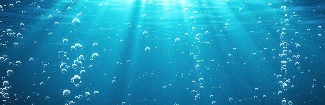 Blue underwater scene with bubbles and light rays filtering through the water.