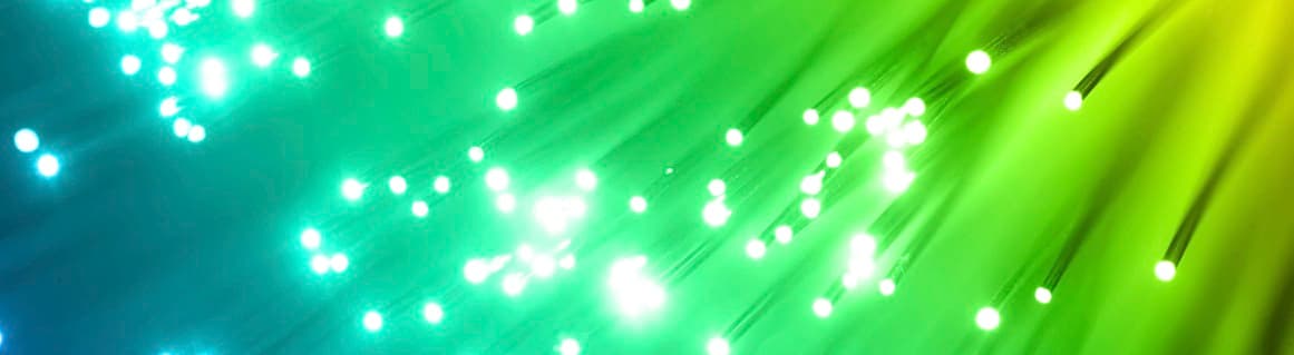 Abstract background with green and blue light streaks and glowing white dots, symbolizing energy and innovation.