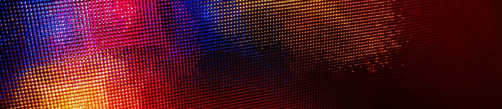 Abstract colorful pixelated background in blue, red, and orange tones.