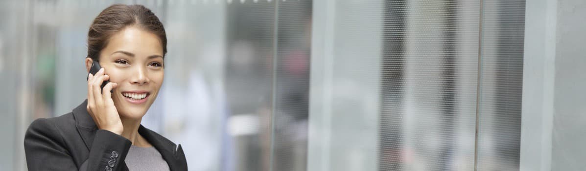 Woman smiling as she talks on a mobile phone